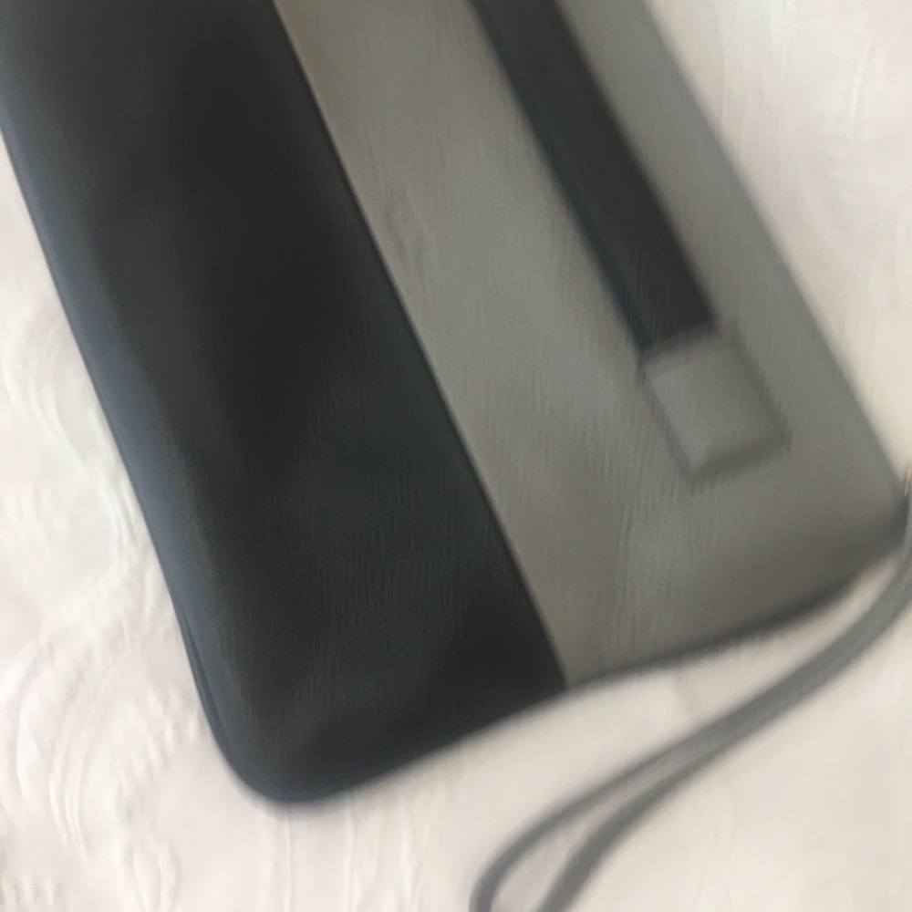 PERLINA clutch, end loop strap. 12-1/2”x 8-1/2” leather 2-tone black & gray.